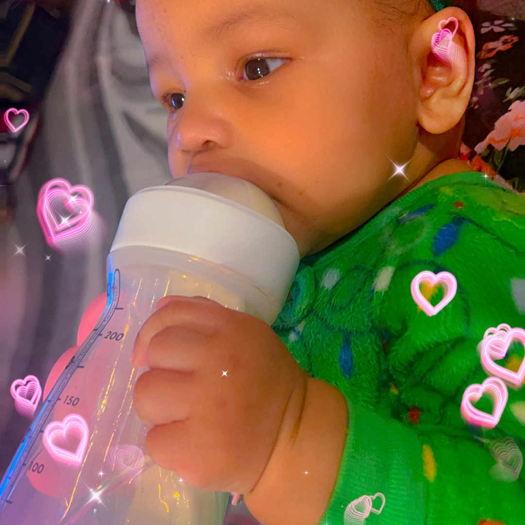 Layla-Grace joined the competition — help win amazing prizes! accessories, baby, beverage, bodypart, bottle, cup, earring, face, finger, hand, head, jewelry, jug, milk, person, photography, portrait, purple, shaker, waterbottle