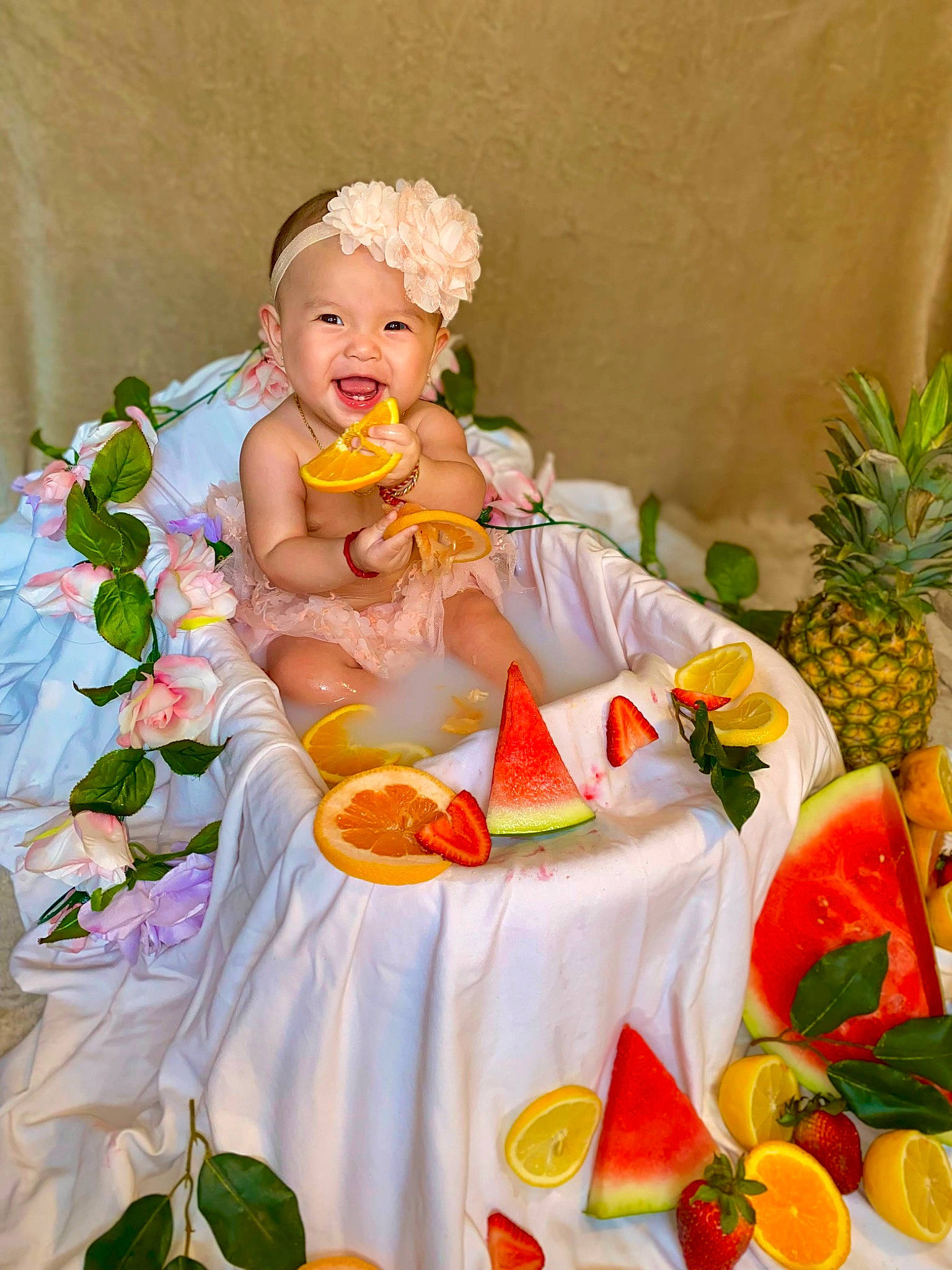 Jade is registered to the contest to win money with this photo: ananas, baby, baby_toddler_clothing, event, floral_design, flower_arranging, food, food_group, fruit, happy, headwear, ingredient, natural_foods, orange, peach, person, petal, pineapple, plant, smile