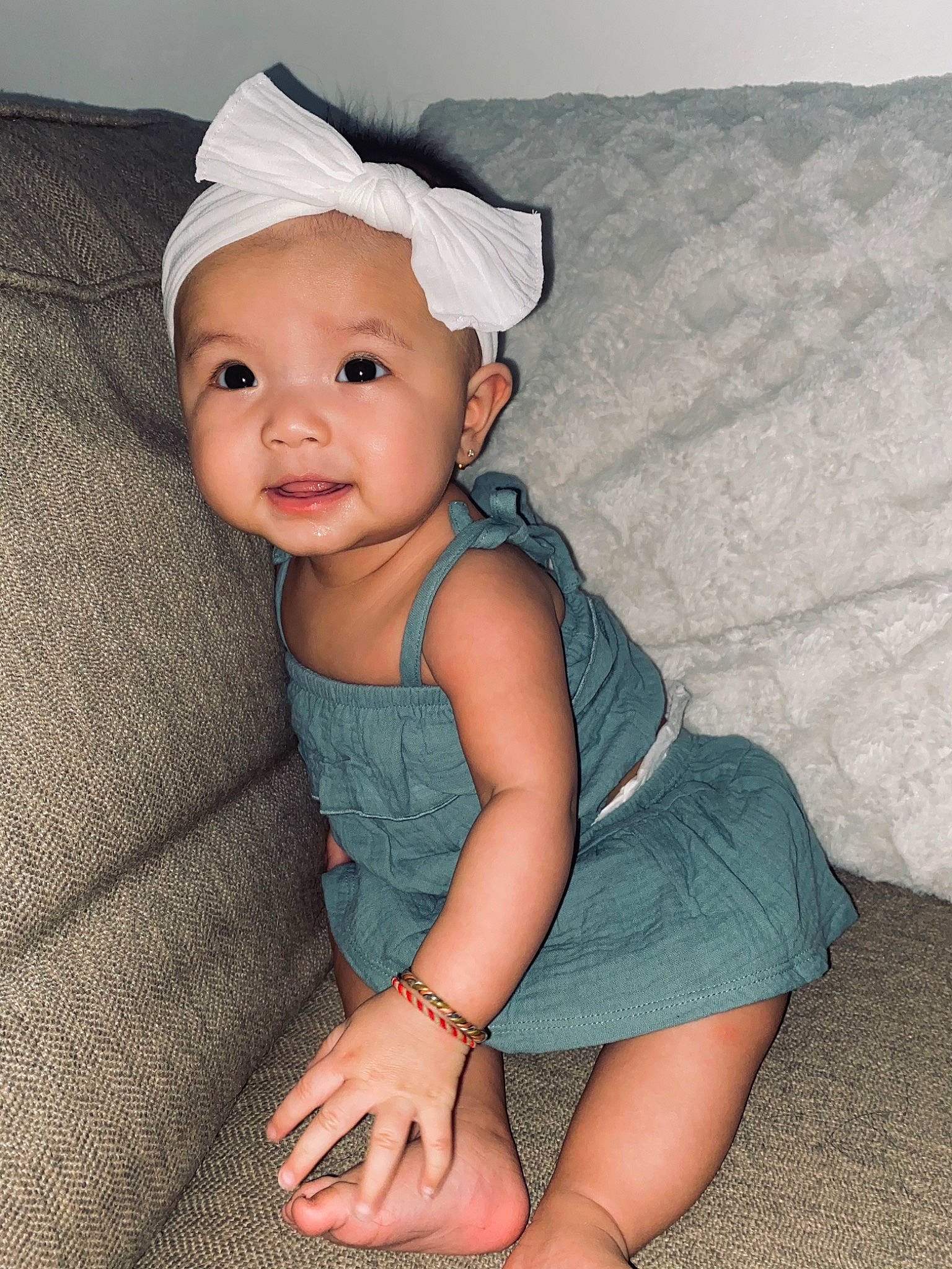 Jade is registered to the contest to win money with this photo: baby, baby_toddler_clothing, cap, chin, comfort, dress, eye, face, flash_photography, happy, head, headwear, human_body, iris, knee, lip, person, skin, sleeve, smile
