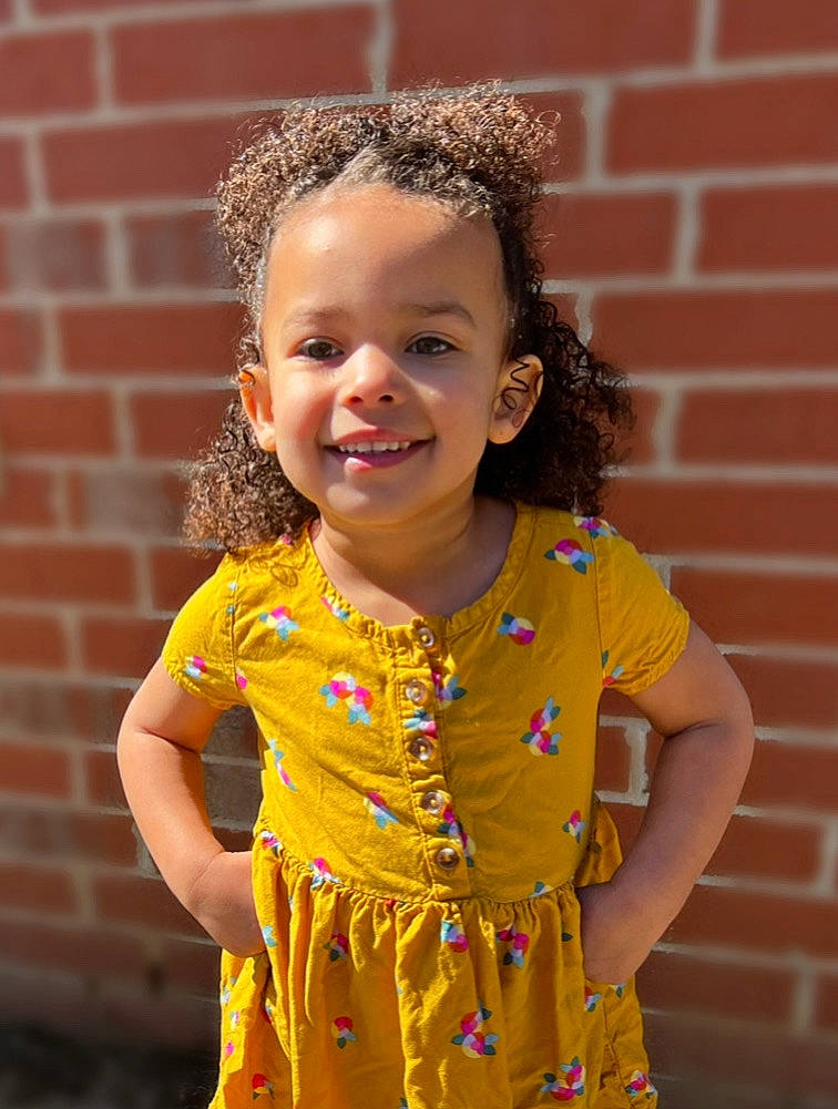 Pyper is registered to the contest to win money with this photo: baby_toddler_clothing, beauty, brick, child, chin, eye, fun, grass, hairstyle, happy, iris, joy, neck, orange, person, pink, skin, sleeve, smile, standing