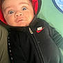baby, hoodie, nike, black_clothing, red_hood, blue_blanket, green_background, infant, face, eyes, expression, zipper, casual_wear, indoors, child, portrait, young_child, clothing, person, cute