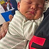 Dawson is registered to the contest to win money with this photo: baby, sleeping, infant, person, onesie, striped_clothing, closeup, face, peaceful, cute, newborn, hand, holding, indoor, portrait, soft_light, resting, toddler, parent, cuddle