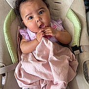 Ezlynn is registered to the contest to win money with this photo: baby, infant, child, blanket, baby_seat, cushion, curly_hair, pink, leggings, pattern, socks, indoors, carpet, comfort, cute, portrait, seated, hands, expression, young