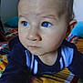 Lorenzo participe au concours pour gagner de l'argent avec cette photo : baby, blue_eyes, close_up, curious, face, infant, indoors, looking_away, navy_blue_clothing, portrait, resting, striped_blanket, toddler, young_child, colorful, soft_light, cute, child, person, bedspread