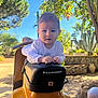baby, child, scooter, piaggio, outdoor, sunny, greenery, plants, tree, seat, hands, face, expression, daylight, vehicle, transportation, casual, nature, portrait, person
