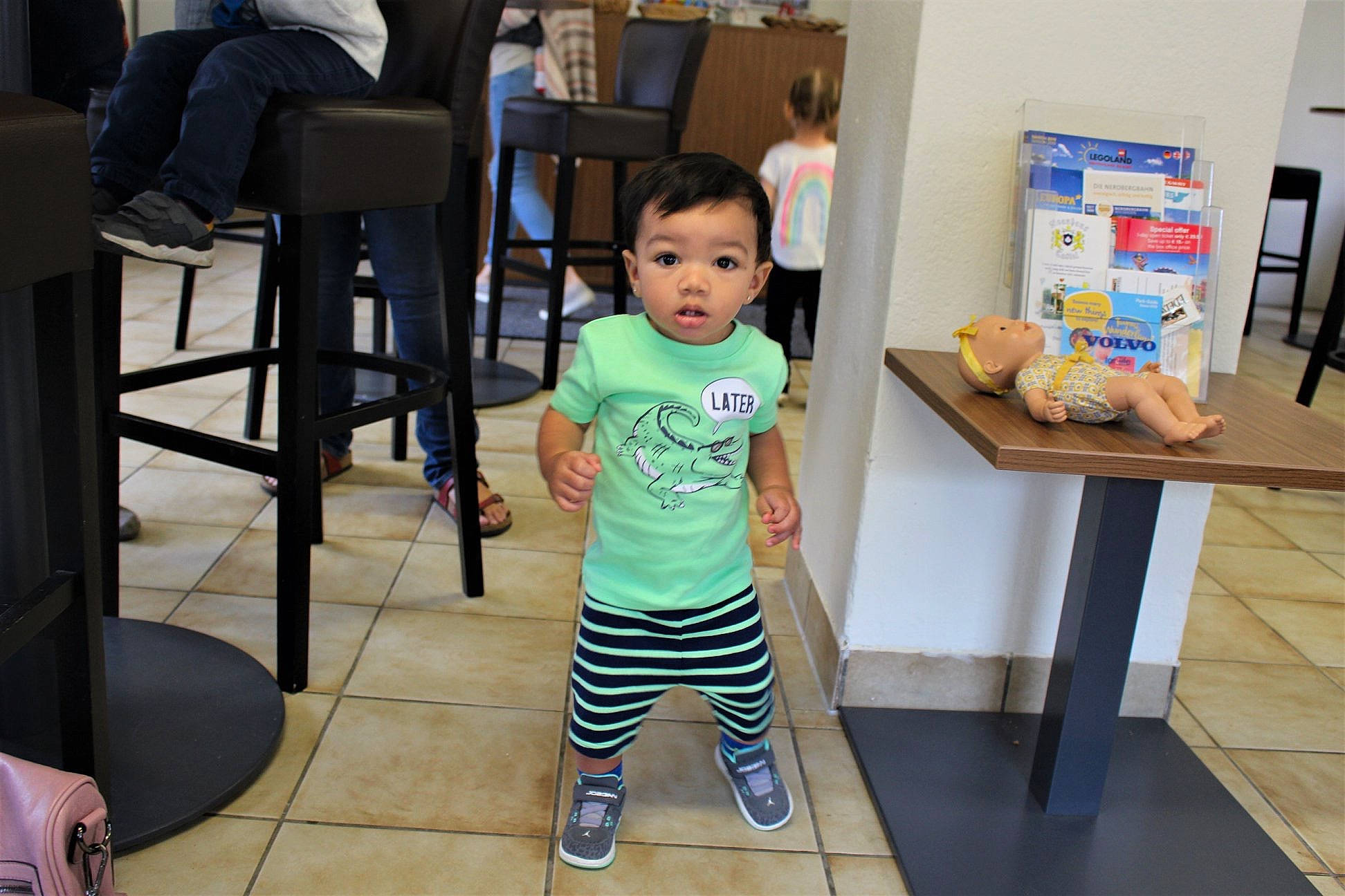 Lee is registered to the contest to win money with this photo: baby, child, flooring, furniture, person, room, standing, surprise, toddler, vacation