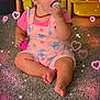 Jazmine joined the competition — help win amazing prizes! toddler, child, baby, carpet, toy, pink_clothing, overalls, necklace, sitting, indoors, storage_bins, sparkles, heart_overlay, cute, playful, curious, floor, skin, face, hand