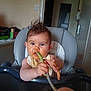 baby, high_chair, spoon, messy_face, curly_hair, blue_eyes, feeding, kitchen, indoor, bib, food_smear, child, person, furniture, table, curious, messy, infant, face, hands