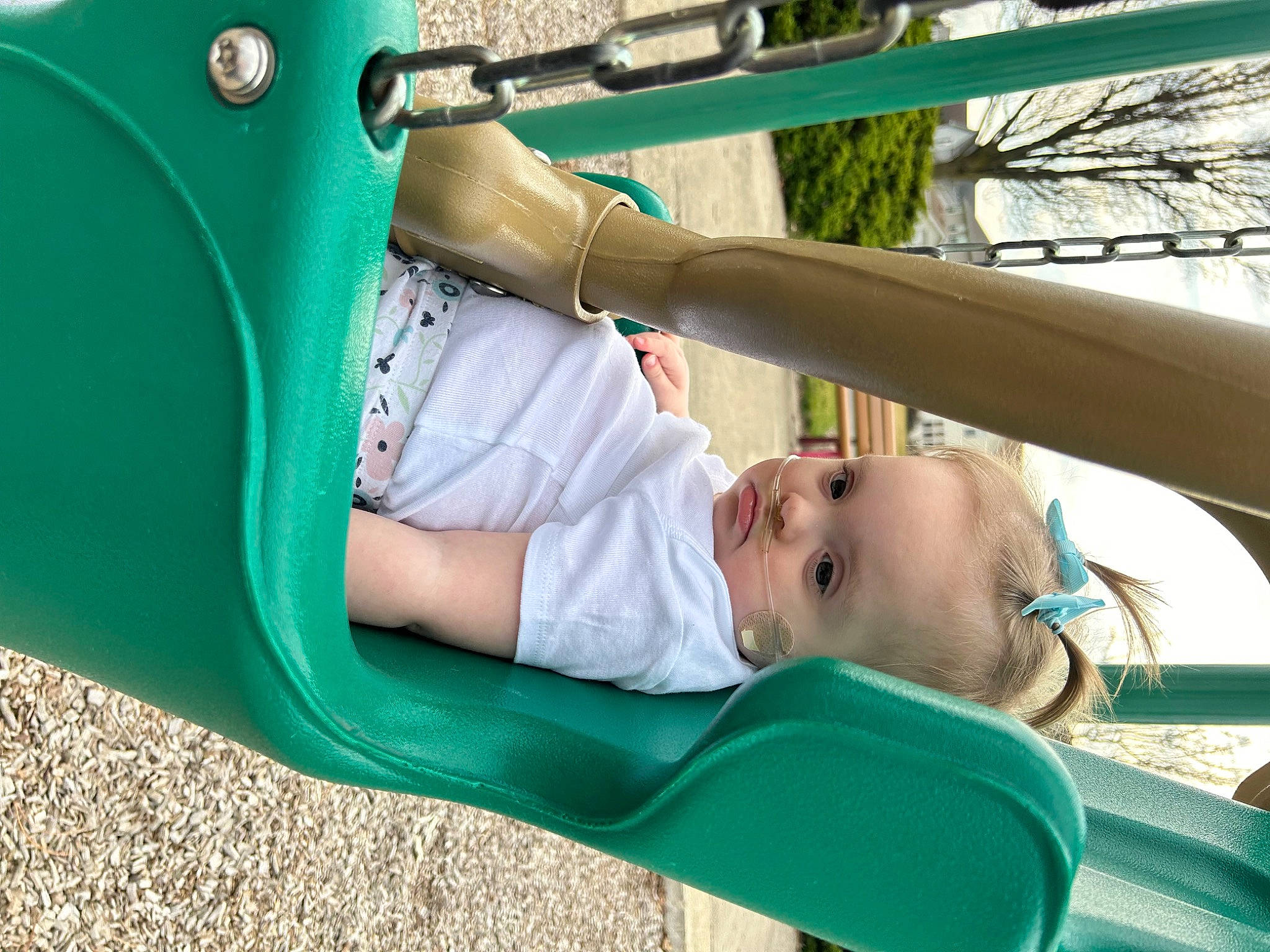 Laila joined the competition — help win amazing prizes! child, city, comfort, fun, grass, green, hand, head, human_body, leg, leisure, outdoor_play_equipment, person, play, recreation, shade, sitting, swing, toddler, tree