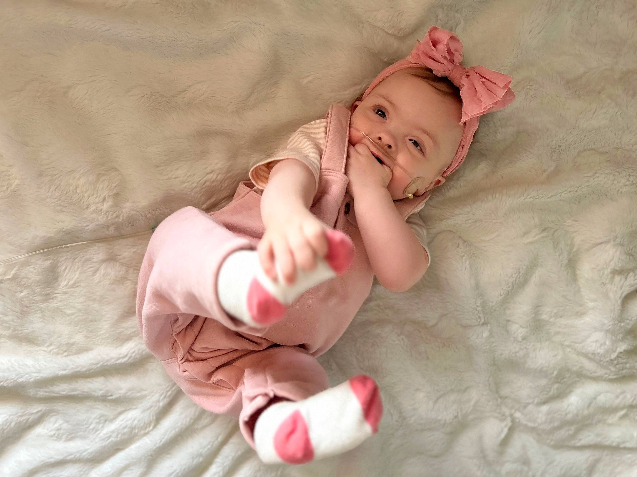 Laila joined the competition — help win amazing prizes! baby, baby_toddler_clothing, cheek, child, comfort, finger, flesh, foot, gesture, happy, human_leg, linens, nail, person, pink, room, skin, sleeve, textile, thumb