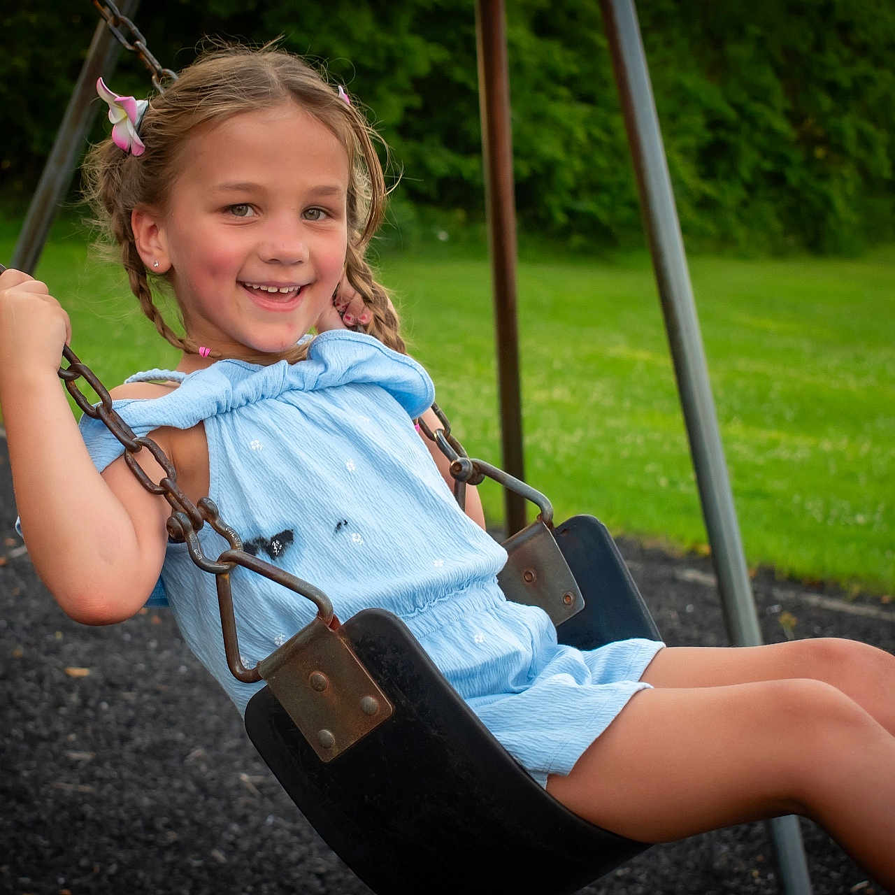 Mia joined the competition — help win amazing prizes! child, clothing, face, female, girl, grass, head, nature, outdoorplayarea, outdoors, park, person, photography, plant, playarea, portrait, shorts, sitting, swing, toy