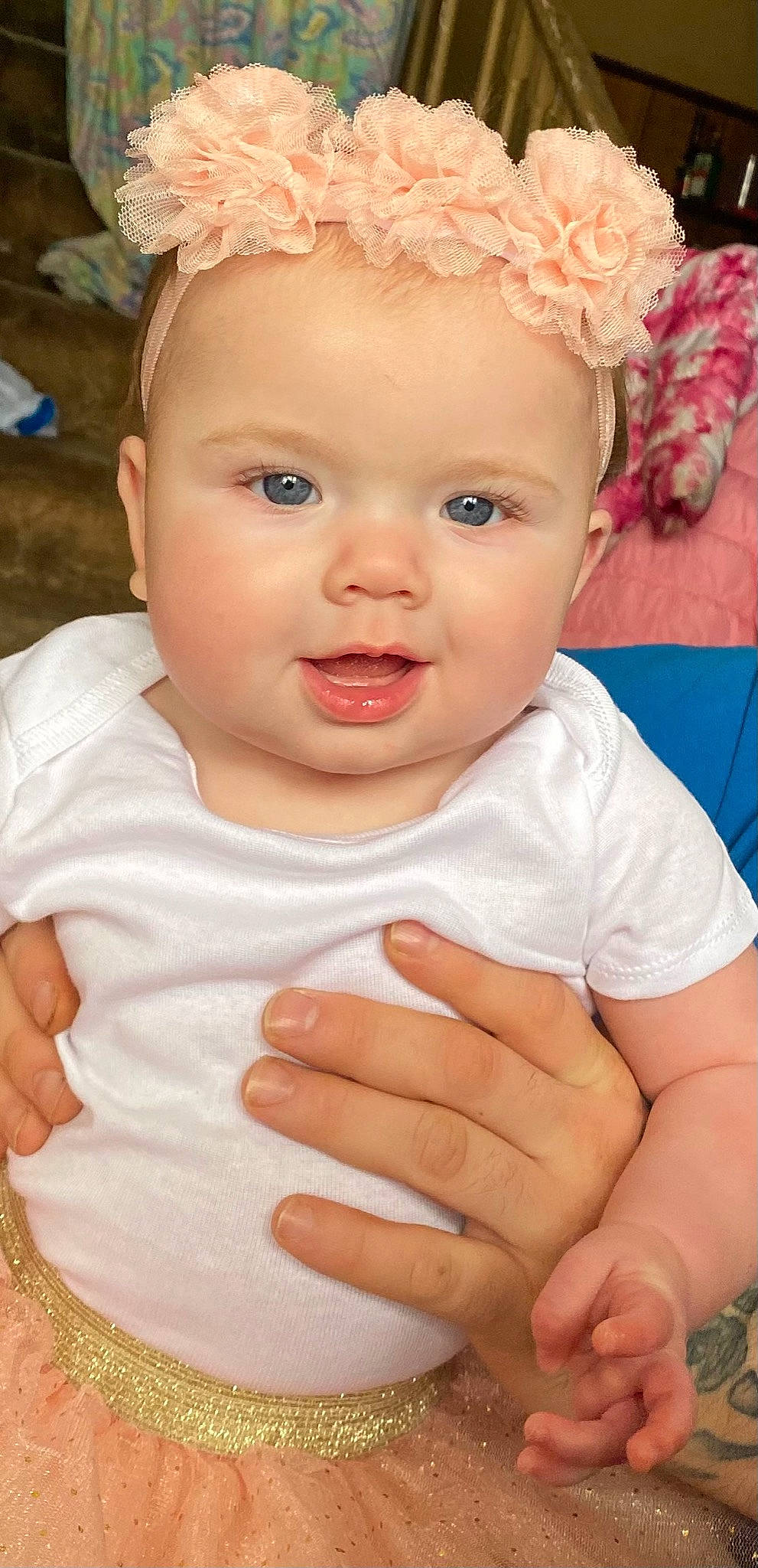 Makenna is registered to the contest to win money with this photo: arm, baby_toddler_clothing, cheek, chin, eye, eyebrow, eyelash, face, facial_expression, finger, gesture, hand, happy, head, headwear, iris, lip, nose, person, pink