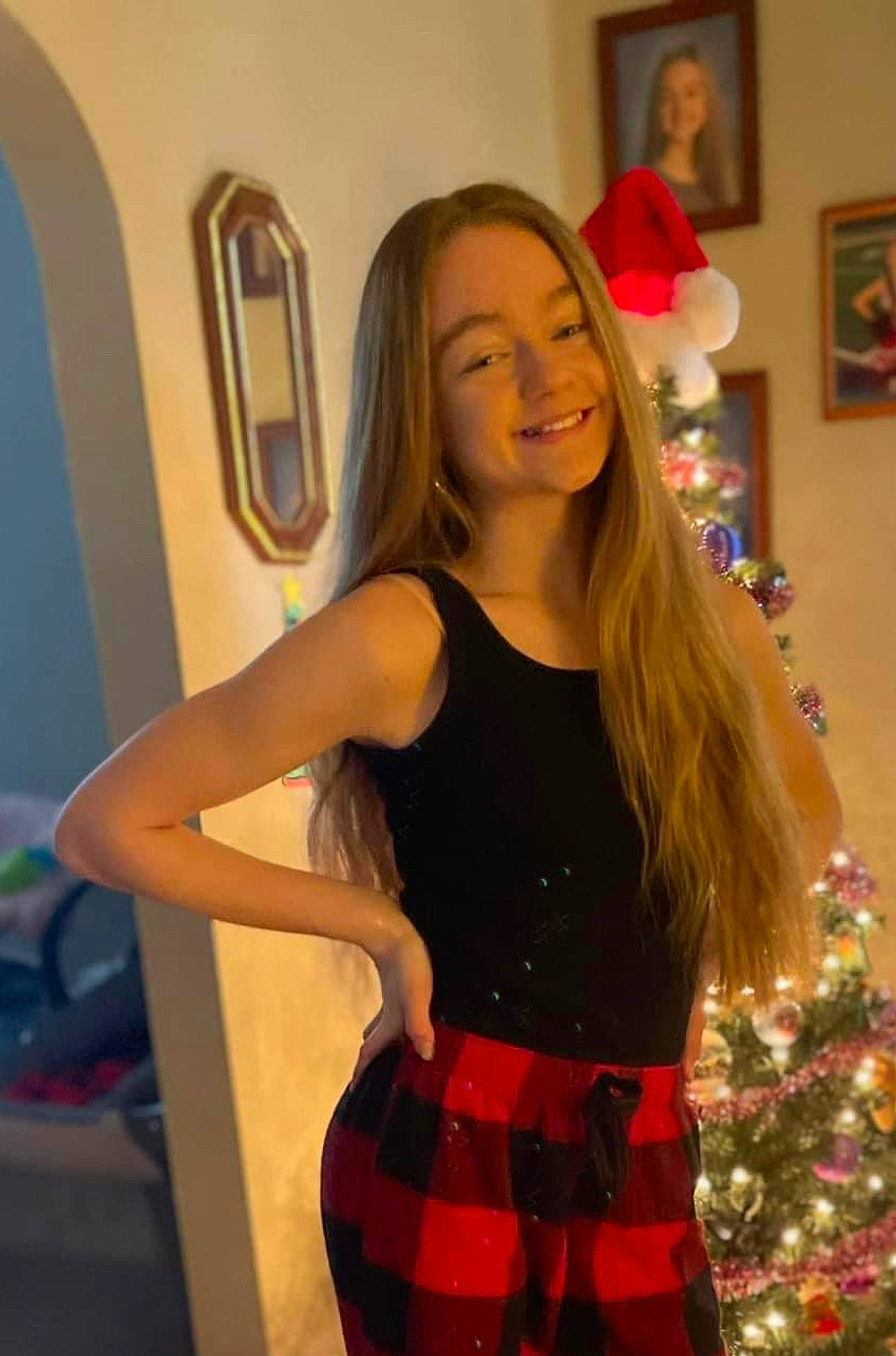 Madison is registered to the contest to win money with this photo: beauty, blurred, christmas_ornament, christmas_tree, event, fashion, fashion_design, fun, hairstyle, happy, human_leg, joy, long_hair, mirror, person, picture_frame, plaid, smile, standing, tartan