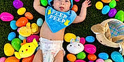 Mikey joined the competition — help win amazing prizes! baby, balloon, cap, clothing, diaper, face, food, footwear, grass, hat, head, outdoors, people, person, photography, plant, portrait, purple, shorts, sweets