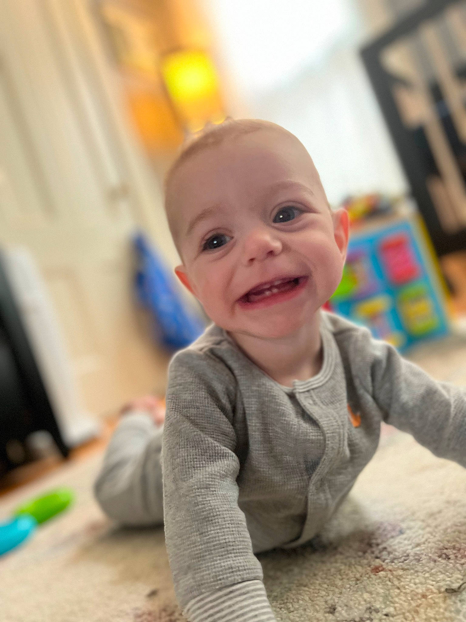 Gabriel is registered to the contest to win money with this photo: baby, baby_toddler_clothing, cheek, child, eye, floor, flooring, fun, happy, head, joy, laugh, leisure, nose, person, play, room, sitting, skin, smile