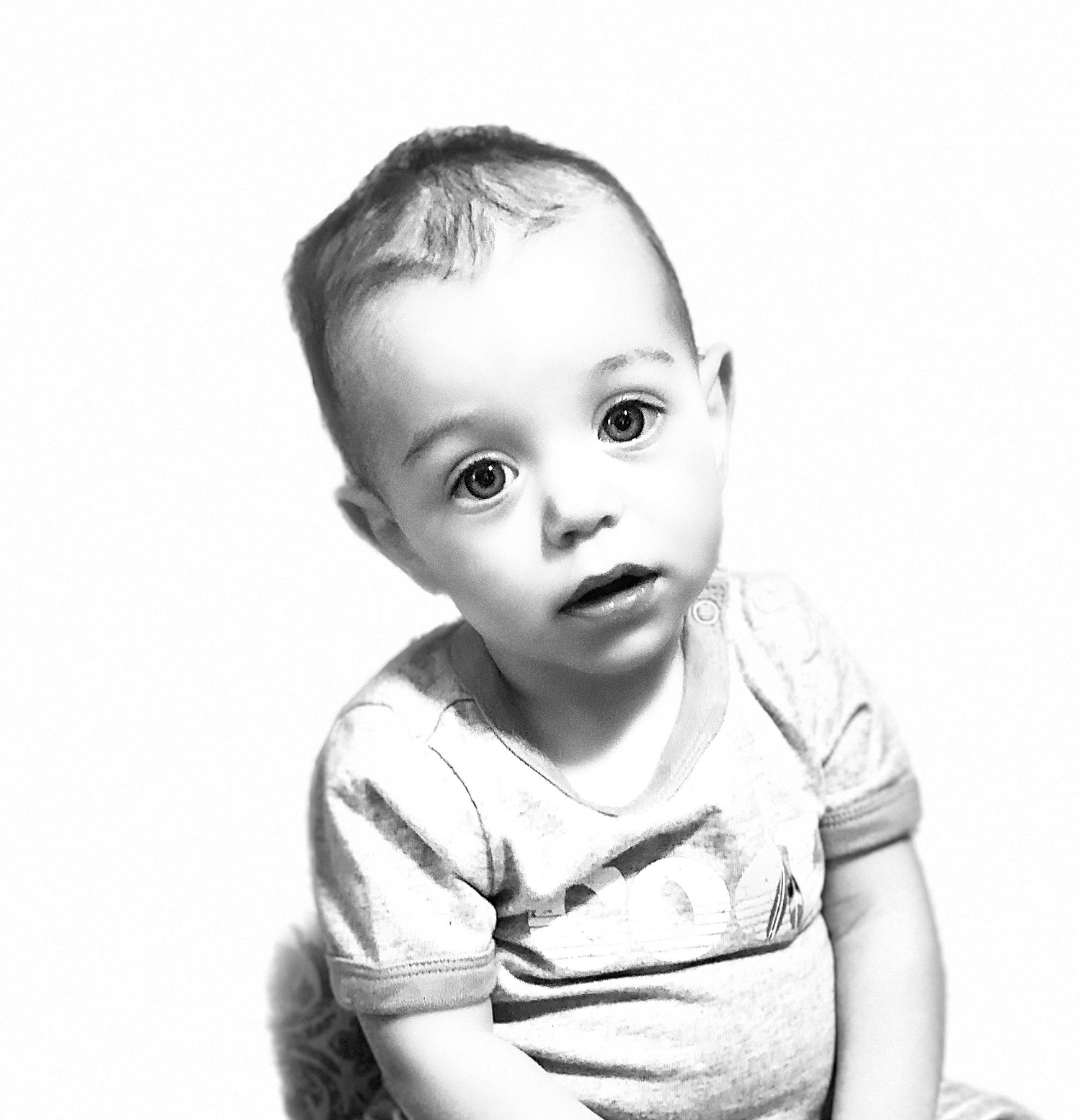 Gabriel is registered to the contest to win money with this photo: baby, baby_toddler_clothing, black_and_white, cheek, child, eyelash, flash_photography, happy, human, monochrome, monochrome_photography, no_expression, person, portrait, portrait_photography, sitting, sleeve, stock_photography, toddler