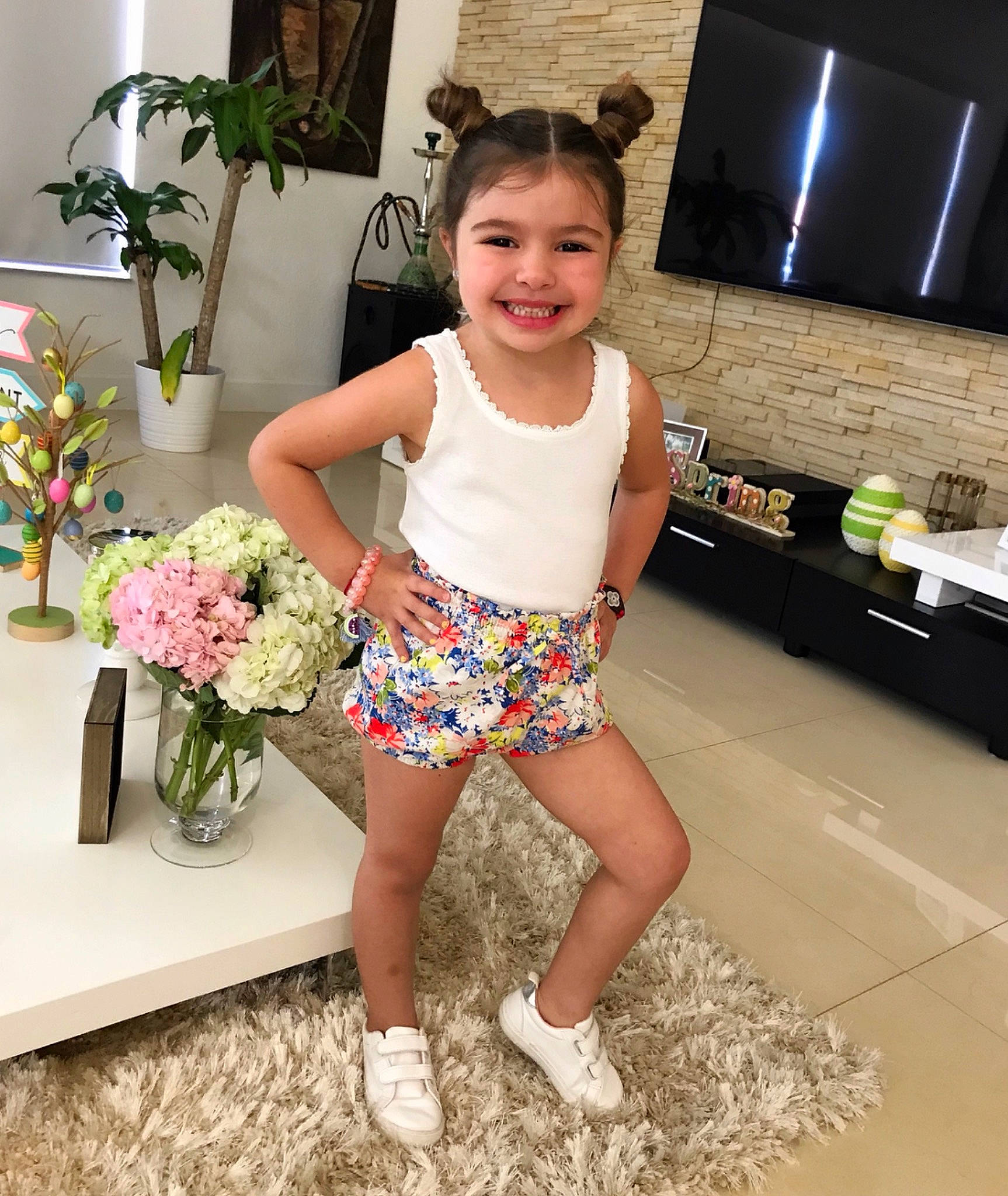 Megan is registered to the contest to win money with this photo: child, child_model, clothing, flower, footwear, joy, knee, leg, person, plant, shoe, shorts, shoulder, smile, thigh, toddler