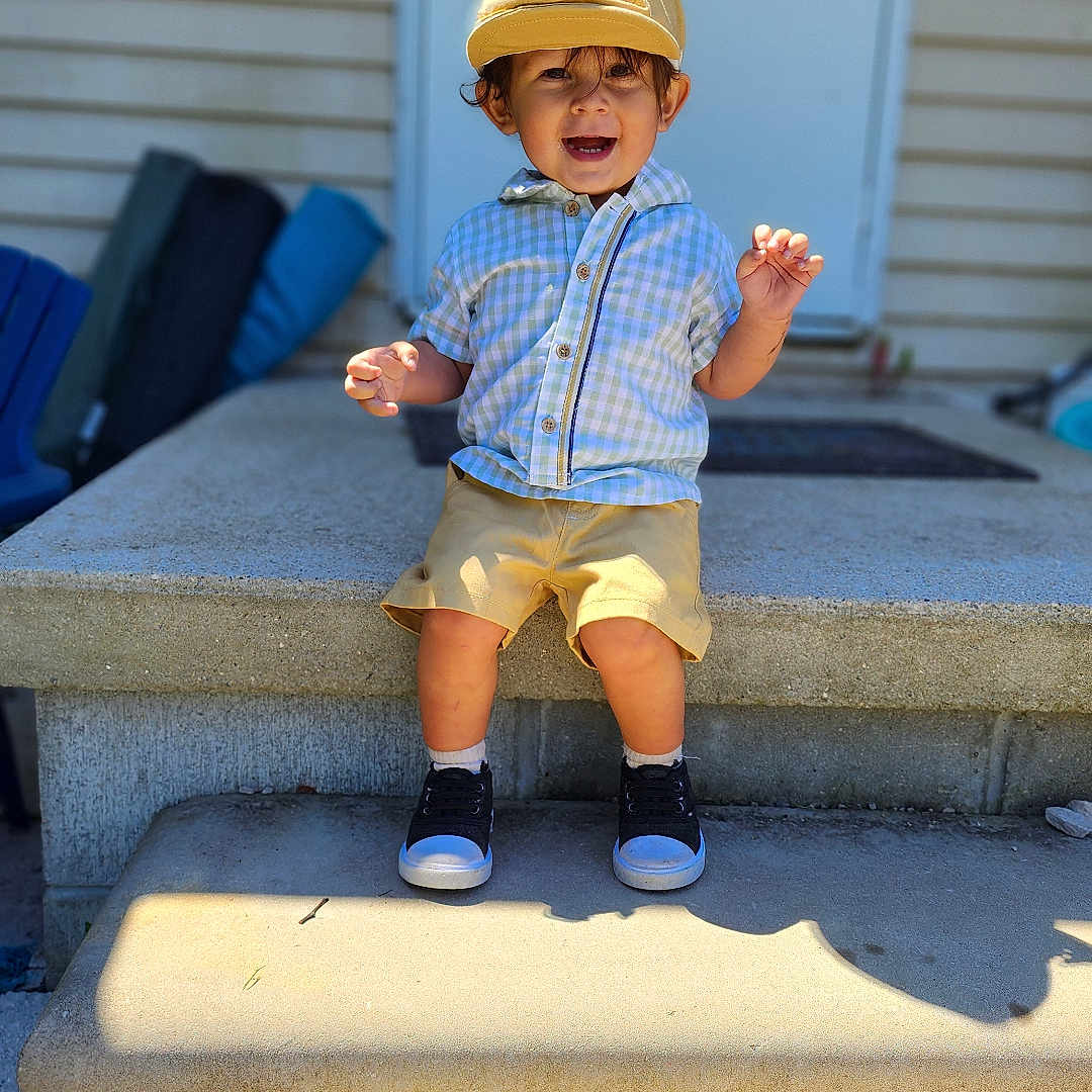 Atticus is registered to the contest to win money with this photo: baseballcap, bodypart, boy, child, clothing, face, finger, footwear, hand, hat, head, male, pants, person, photography, plant, portrait, shoe, shorts, sitting