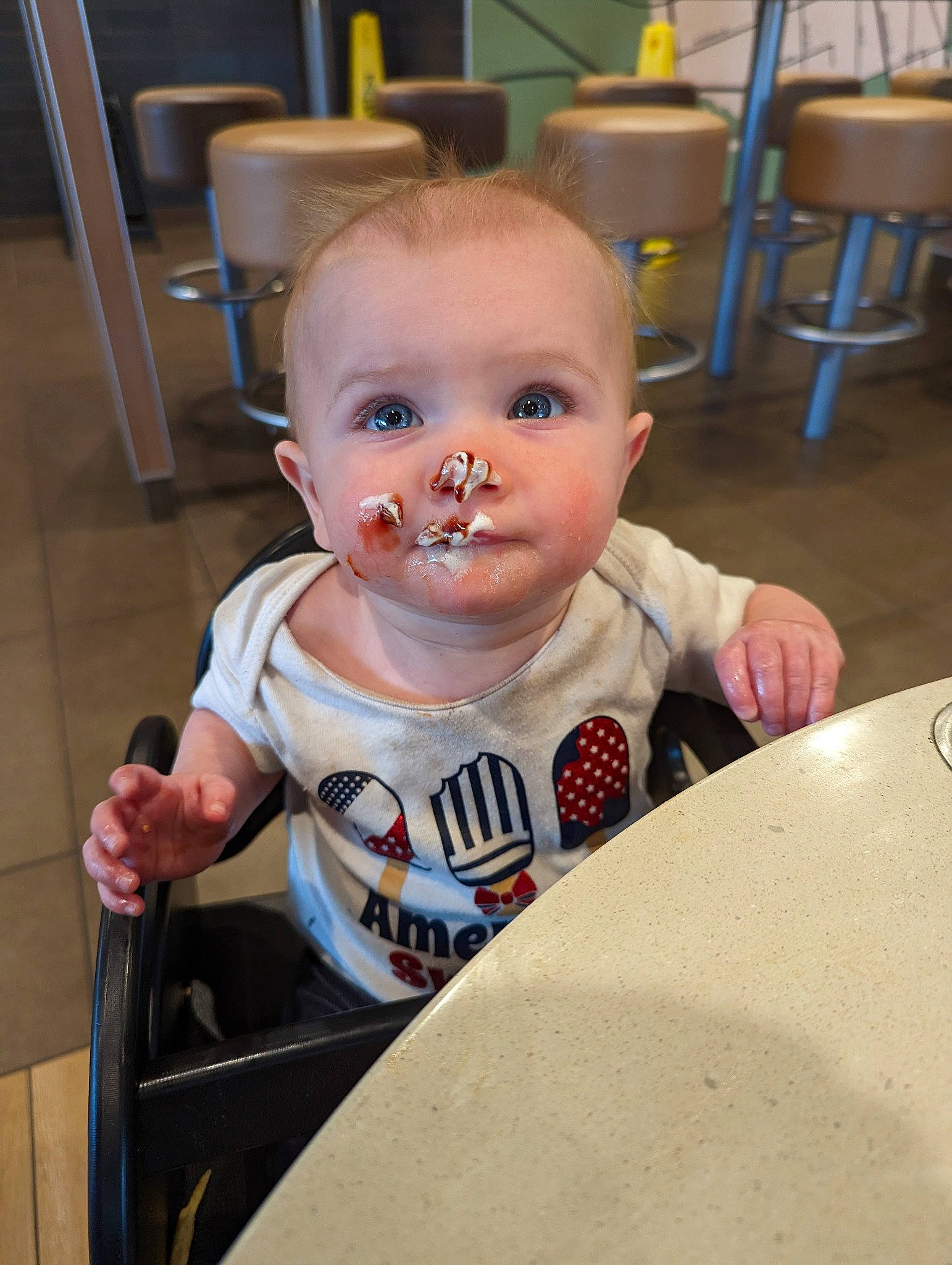 Cora joined the competition — help win amazing prizes! baby, baby_toddler_clothing, chair, cheek, child, eye, facial_expression, food, fun, mouth, person, sitting, skin, sleeve, t_shirt, toddler, vacation