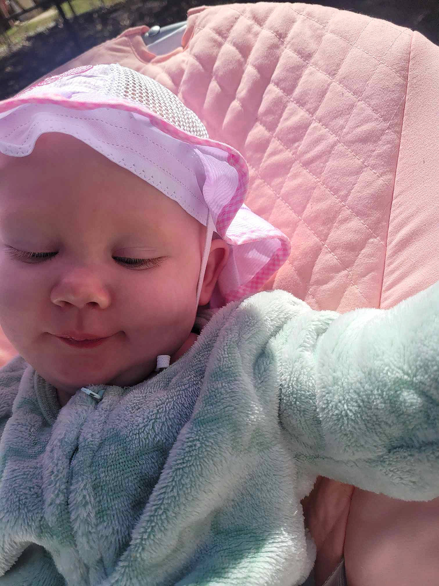 Daphne is registered to the contest to win money with this photo: baby, baby_products, baby_toddler_clothing, cap, cheek, comfort, eyebrow, eyelash, finger, headwear, iris, linens, lip, magenta, mouth, nose, person, pink, skin, sleeve