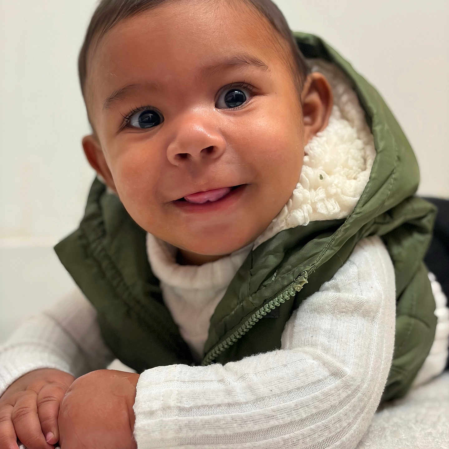 Noah Jeuniel joined the competition — help win amazing prizes! baby, child, closeup, crawling, cute, eyes, face, fluffy_surface, green, hand, happy, indoor, infant, portrait, skin, smile, tongue, vest, warm_clothing, white_sweater