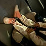 child, car_seat, pajamas, socks, hands, legs, vehicle_interior, seat, straps, safety, infant, baby, clothing, car, seatbelt, cozy, dim_lighting, travel, comfort, young_child