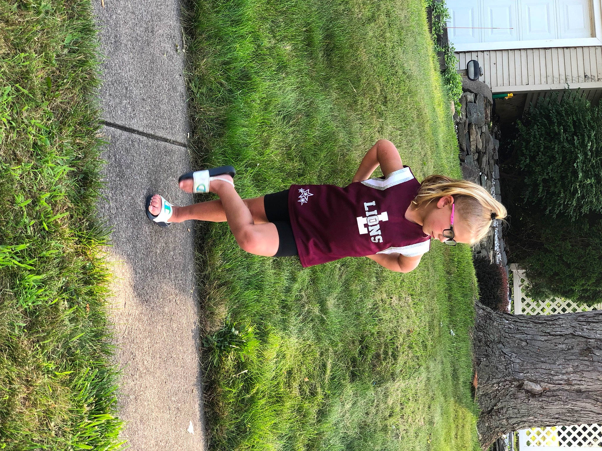 Avianna is registered to the contest to win money with this photo: elbow, fun, grass, happy, hat, knee, leisure, people_in_nature, person, plant, recreation, shorts, shrub, t_shirt, thigh, toddler, tree, trunk, walking_shoe