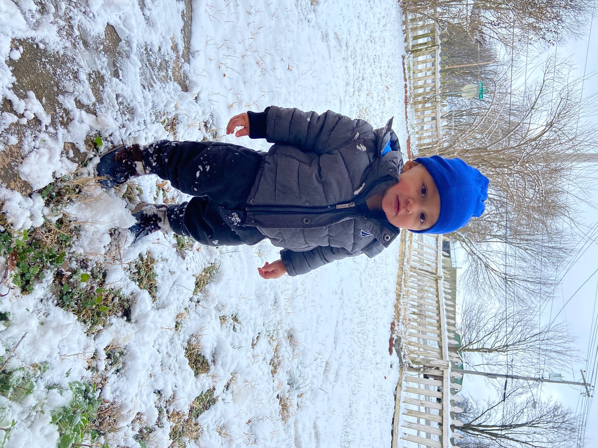 Jaiden is registered to the contest to win money with this photo: adventure, child, electric_blue, freezing, frost, fun, grass, headwear, ice_cap, jacket, leisure, people_in_nature, person, plant, playing_in_the_snow, recreation, slope, snow, toddler, tree