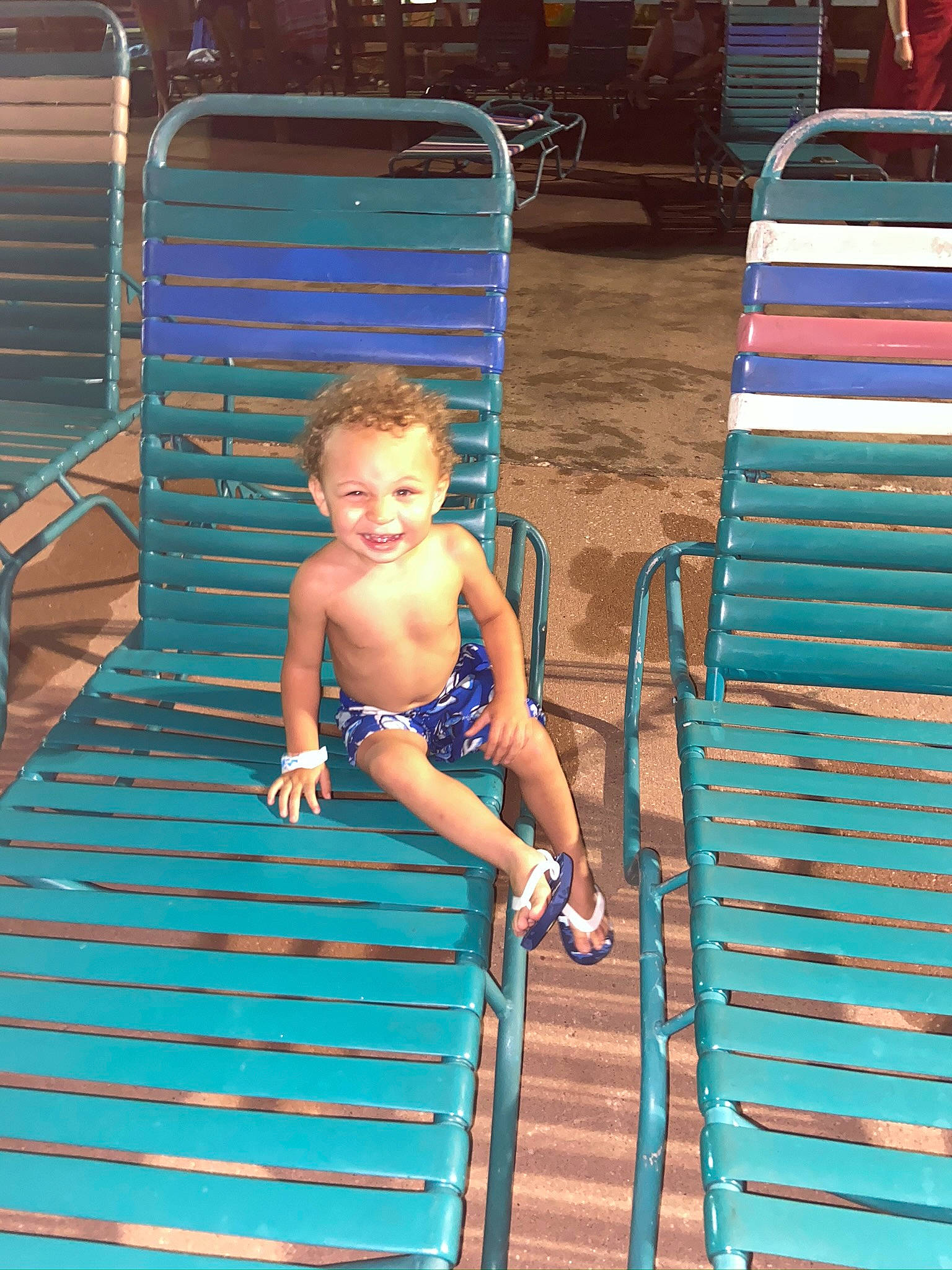 Jamari is registered to the contest to win money with this photo: azure, barefoot, blue, child, electric_blue, fun, green, happy, human, joy, leisure, outdoor_furniture, person, product, sitting, smile, standing, sunglasses, thigh, toddler