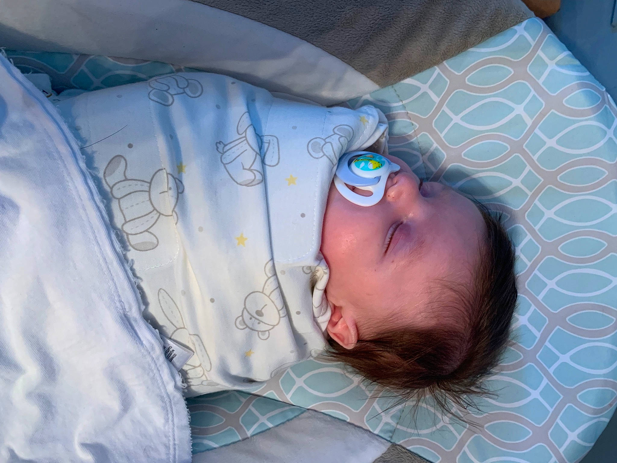 Bryan is registered to the contest to win money with this photo: baby, baby_products, baby_sleeping, baby_toddler_clothing, bedtime, child, comfort, electric_blue, human, linens, mammal, nap, pattern, people, person, product, room, sleep, sleeve, textile