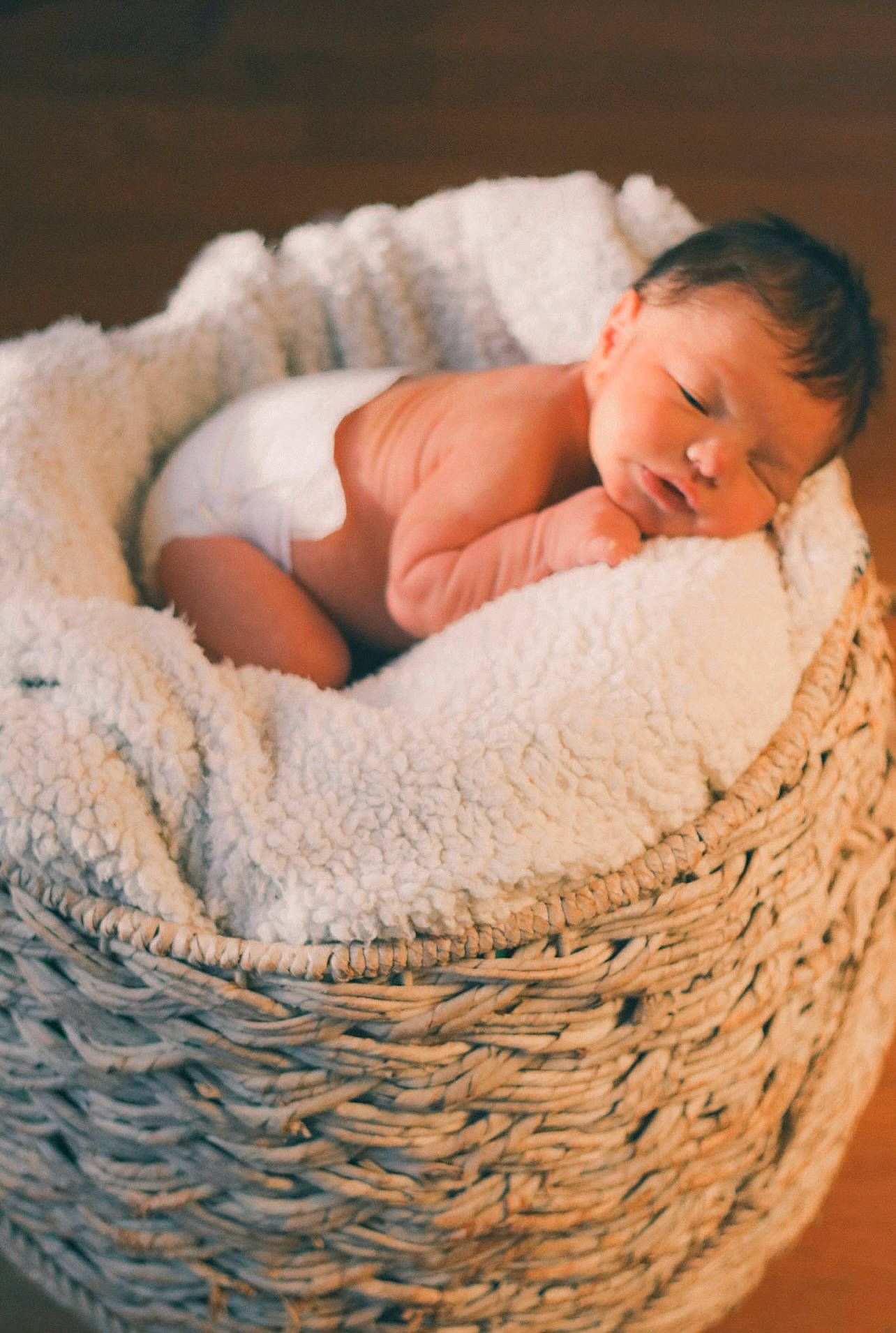 Bryan is registered to the contest to win money with this photo: art, baby, baby_products, baby_sleeping, baby_toddler_clothing, basket, child, comfort, fashion_accessory, fur, hand, linens, pattern, person, storage_basket, textile, toddler, wicker, wood, wool