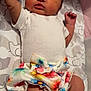 Ivie is registered to the contest to win money with this photo: baby, infant, onesie, floral_skirt, blanket, elephant_pattern, arm_raised, lying_down, cute, newborn, child, indoors, soft_lighting, skin, face, expression, clothing, fabric, pattern, colorful