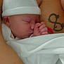 Alexia participe au concours pour gagner de l'argent avec cette photo : newborn, baby, sleeping, blanket, hat, tattoo, hand, skin, closeup, infant, peaceful, resting, wrapped, soft, adult, cradling, comfort, portrait, indoor, care