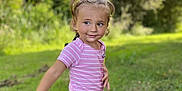 Sonaly a rejoint le concours — aidez-le/la à gagner de superbes lots ! child, toddler, grass, outdoor, nature, smile, pigtails, pink_shirt, koala_pants, playful, greenery, sunlight, young, person, cute, walking, casual_clothing, happy, daylight, portrait