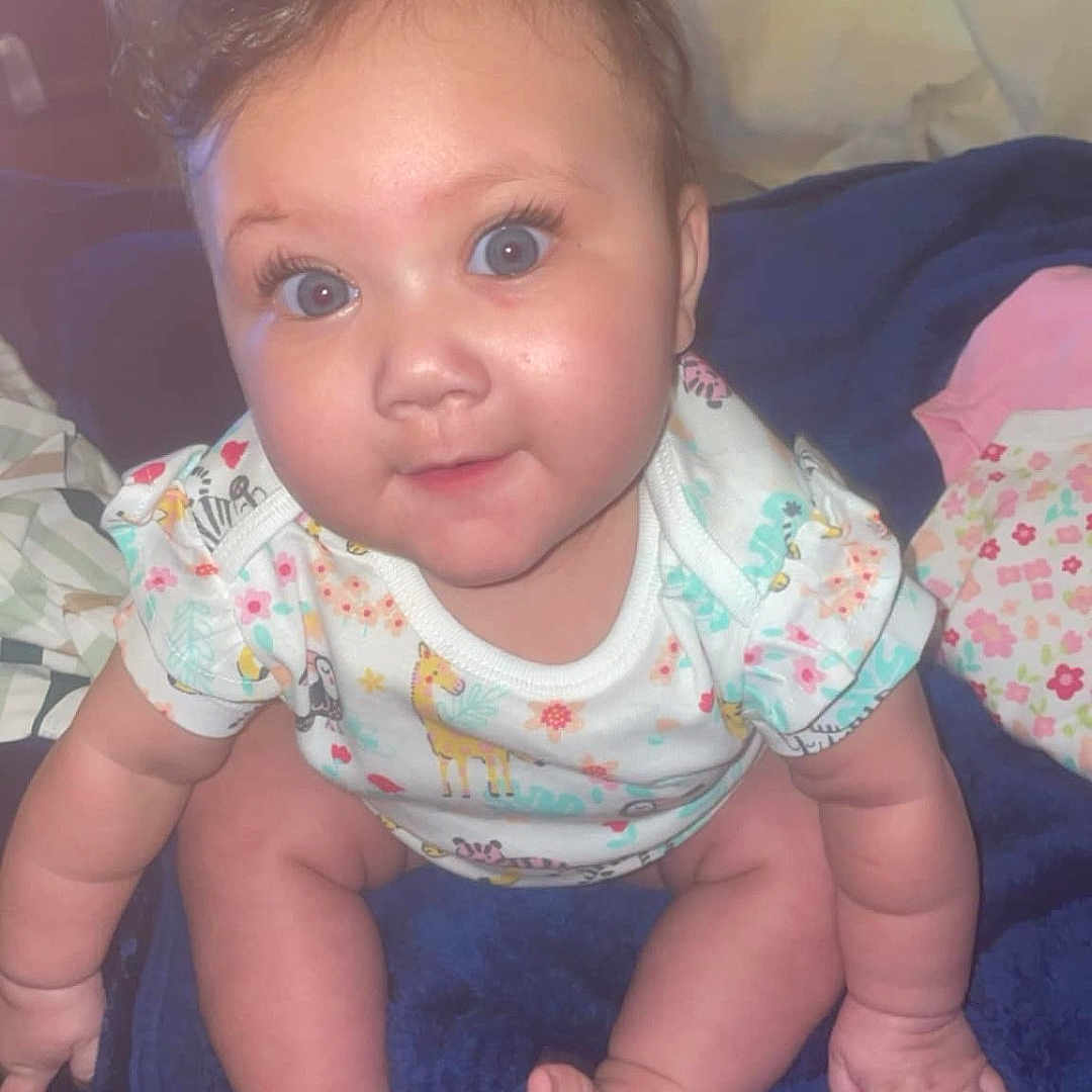 Eliana joined the competition — help win amazing prizes! baby, bed, bedroom, clothing, crawling, cushion, face, furniture, happy, head, homedecor, indoors, pants, person, photography, portrait, quilt, room, sitting, smile