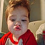 Brayden joined the competition — help win amazing prizes! child, face, portrait, indoors, red_shirt, curly_hair, playful, expression, young_child, toddler, couch, casual_clothing, cute, funny_face, person, sitting, closeup, home, smile, hair