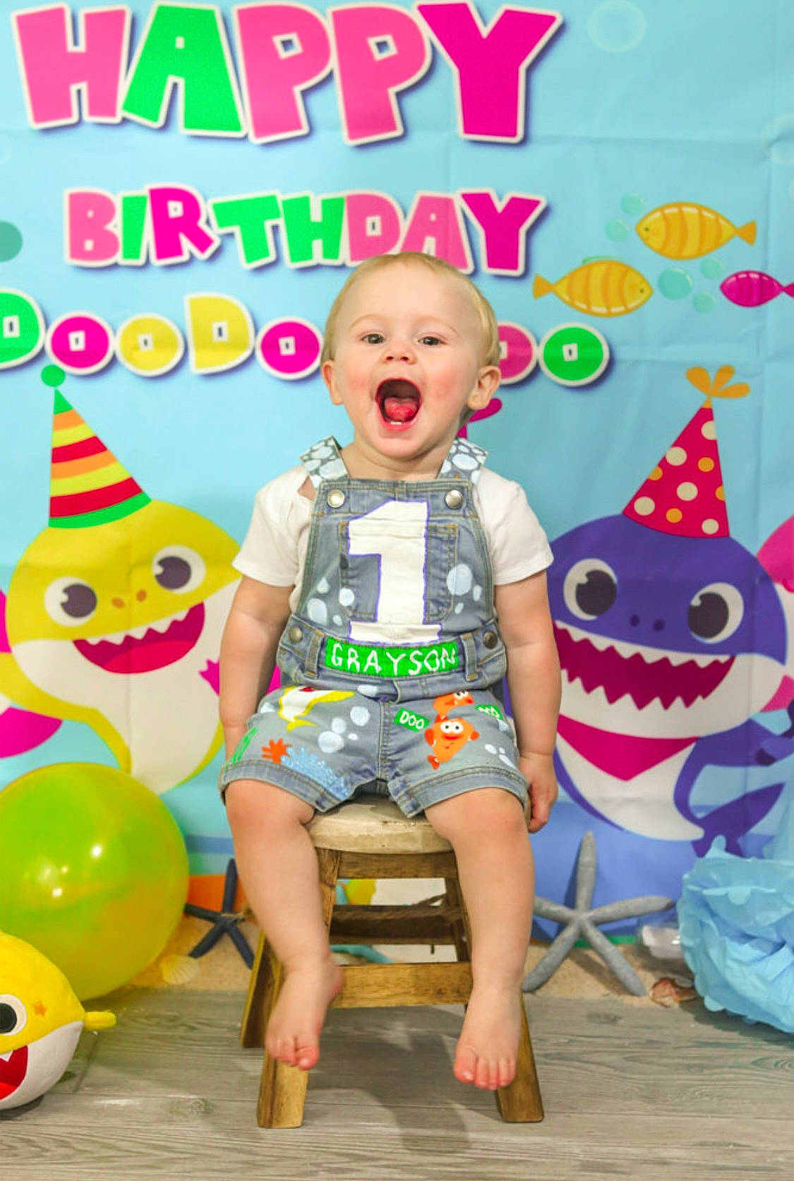 Grayson is registered to the contest to win money with this photo: baby_toddler_clothing, balloon, birthday, child, entertainment, event, fun, happy, leisure, party, party_supply, person, pink, play, sandal, shorts, smile, t_shirt, toddler, toy