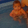 Zayan participe au concours pour gagner de l'argent avec cette photo : baby, child, pool, water, swimming, infant, person, adult_hand, skin, blue, support, sitting, looking, cute, summer, home, background, water_surface, hexagonal_pattern, indoor