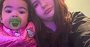 Shaniya is registered to the contest to win money with this photo: baby, casual, child, clothing, curly_hair, expression, face, hair, hand, hello_kitty, indoor, light, long_hair, pacifier, person, pink_jacket, portrait, warm_lighting, woman, young