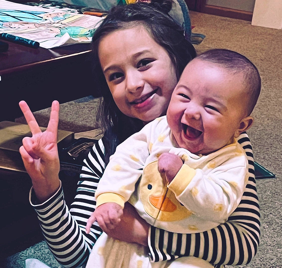 Klay is registered to the contest to win money with this photo: baby, baby_toddler_clothing, cheek, cool, facial_expression, finger, fun, gesture, hand, happy, interaction, joy, mouth, organ, people, person, photograph, sharing, skin, sleeve