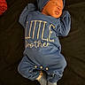 announcement, baby, blanket, blue_onesie, child, clothing, cozy, cute, family, hat, indoor, infant, lying_down, newborn, peaceful, portrait, red_blanket, sleeping, small_person, soft_lighting