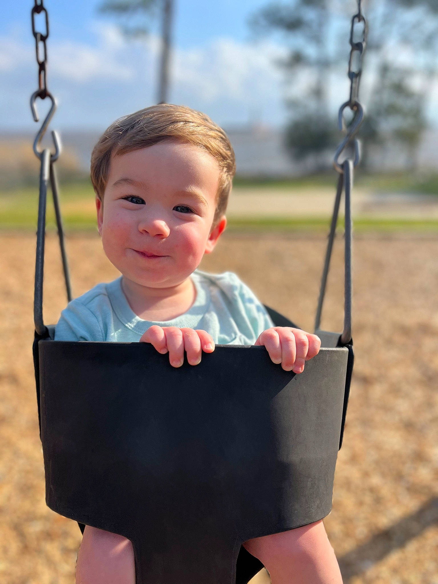 Buckley is registered to the contest to win money with this photo: baby, black, cheek, child, cloud, face, fun, gesture, grass, happy, human_body, joy, leisure, person, photograph, playground, public_space, sky, smile, standing