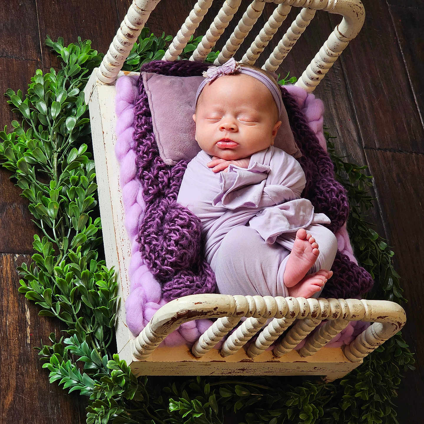 Ava is registered to the contest to win money with this photo: baby, blanket, cozy, cute, decor, floor, greenery, headband, indoor, infant, newborn, peaceful, plants, portrait, purple, resting, sleeping, soft_lighting, swaddled, wooden_bed