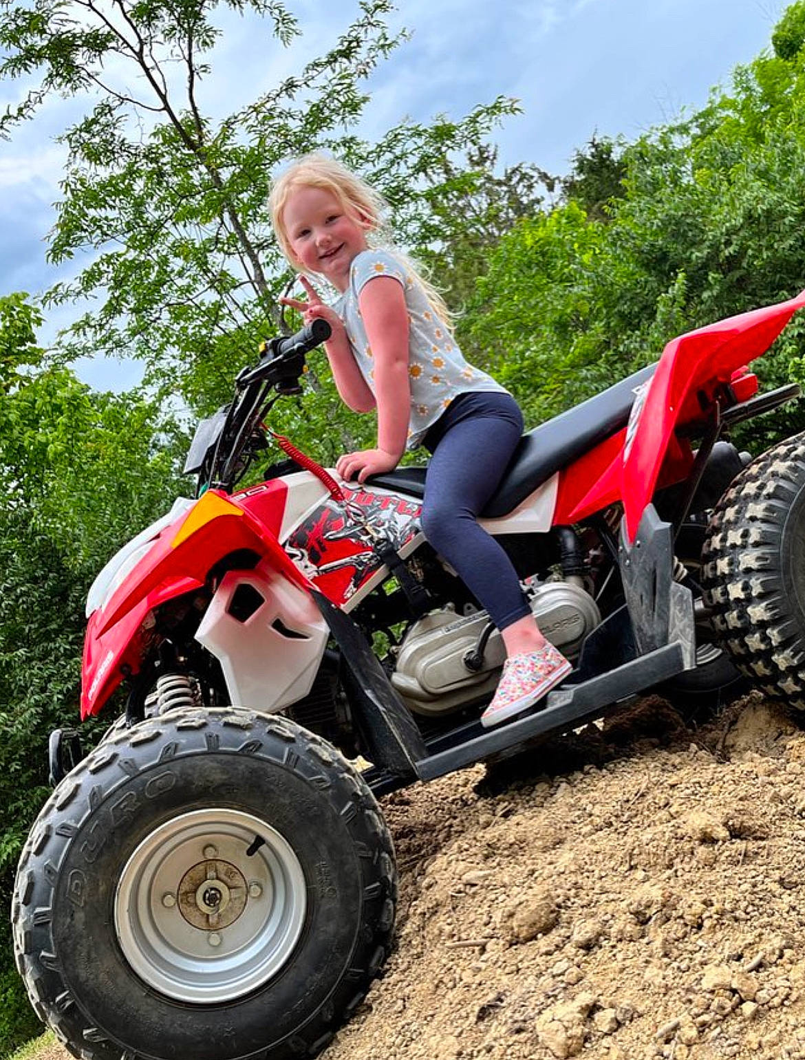 Raya is registered to the contest to win money with this photo: all_terrain_vehicle, automotive_design, automotive_exterior, automotive_tire, automotive_wheel_system, fender, grass, joy, land_vehicle, leg, luggage_and_bags, motor_vehicle, motorsport, outdoor_recreation, person, rim, sky, tire, tread, tree