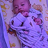 Jasper is registered to the contest to win money with this photo: baby, infant, blanket, swaddle, bed, mattress, winnie_the_pooh, cartoon, child, cute, face, portrait, sleepwear, indoors, soft_toys_pattern, cuddly, resting, hand, expression, purple_light