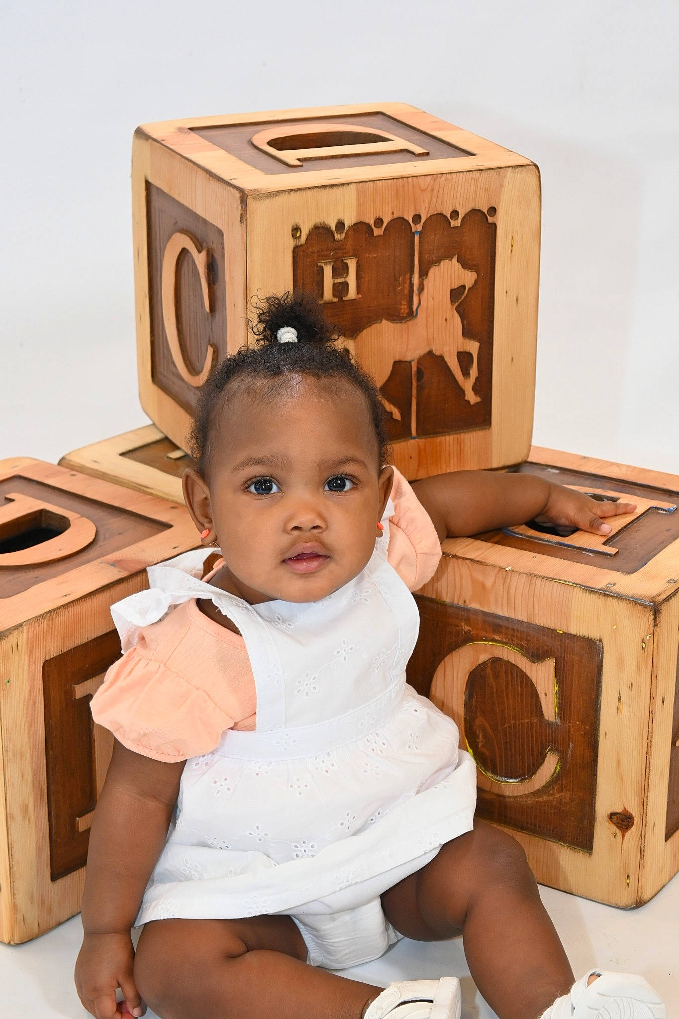 Naomi joined the competition — help win amazing prizes! baby, baby_toddler_clothing, box, cardboard, carton, chair, child, foot, happy, human_leg, jewellery, packaging_and_labeling, person, rectangle, room, shipping_box, sitting, toddler, toy, white