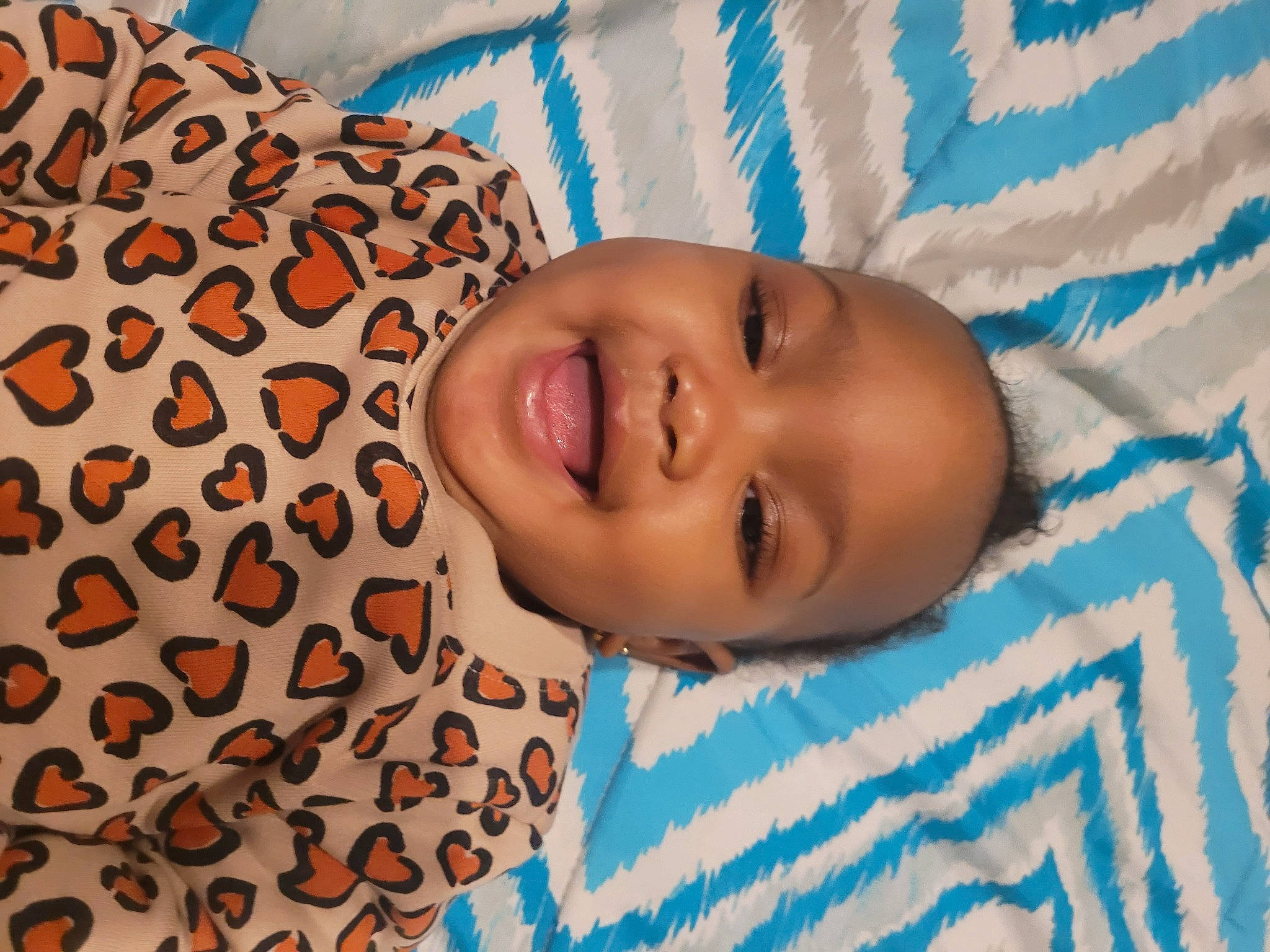 Naomi is registered to the contest to win money with this photo: baby, baby_laughing, baby_products, baby_toddler_clothing, cheek, child, comfort, facial_expression, happy, human_body, iris, linens, mammal, nose, pattern, people, person, skin, smile, toddler
