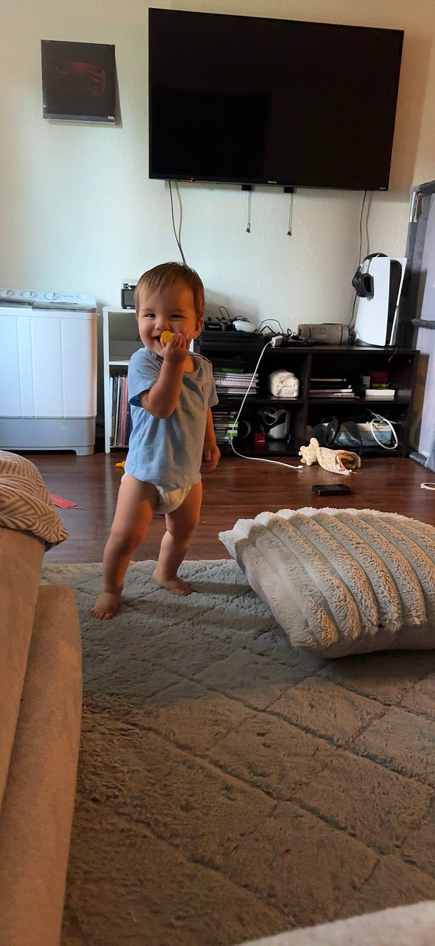 Kian joined the competition — help win amazing prizes! architecture, building, clothing, computerhardware, couch, electronics, entertainmentcenter, face, furniture, hardware, head, indoors, interiordesign, livingroom, monitor, room, screen, shorts, tv, wood