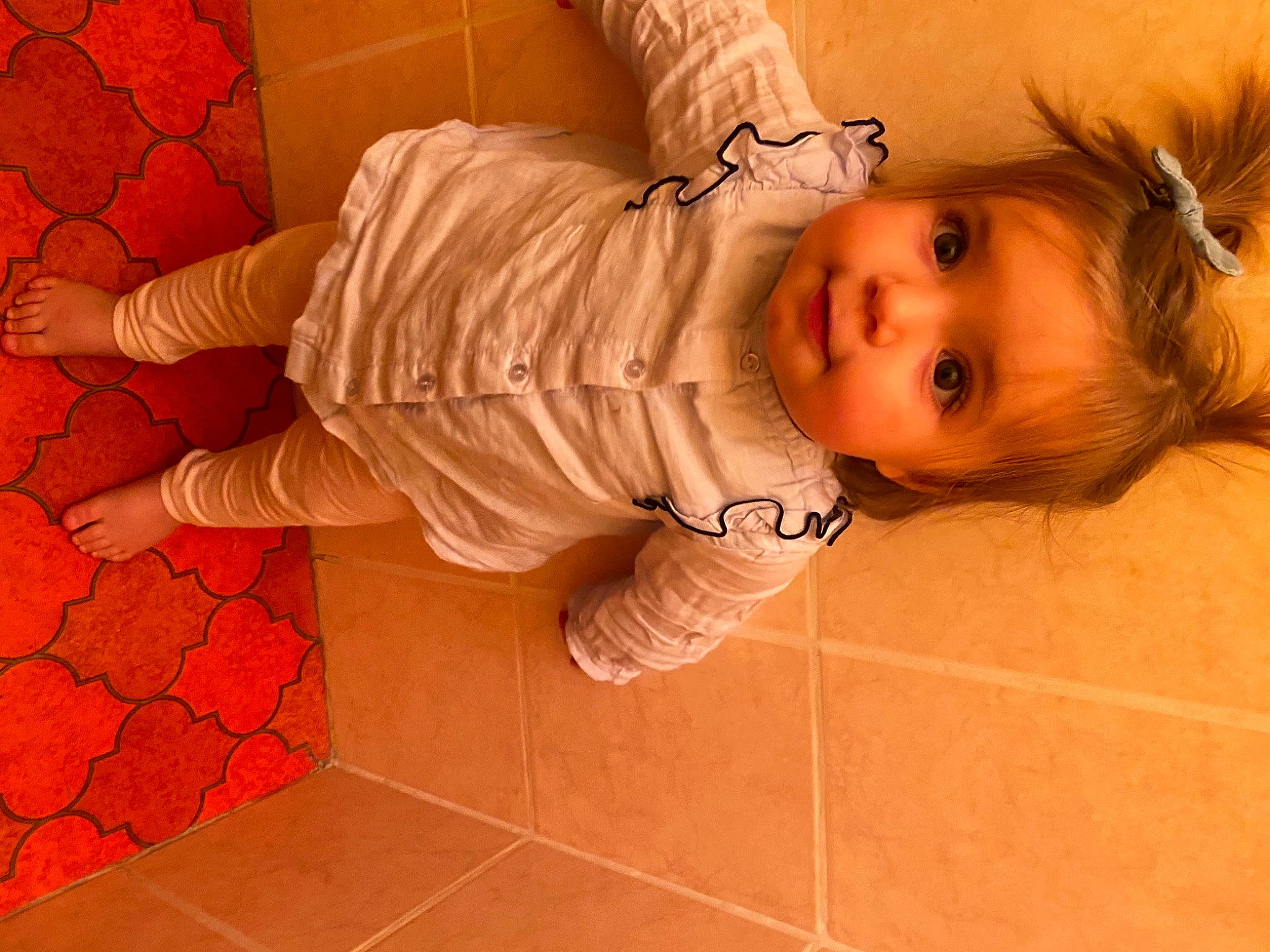 Calie participe au concours pour gagner de l'argent avec cette photo : baby, baby_toddler_clothing, brown_hair, cheek, child, eye, eyelash, floor, flooring, foot, head, human, iris, joint, nose, person, skin, sock, tile, toddler