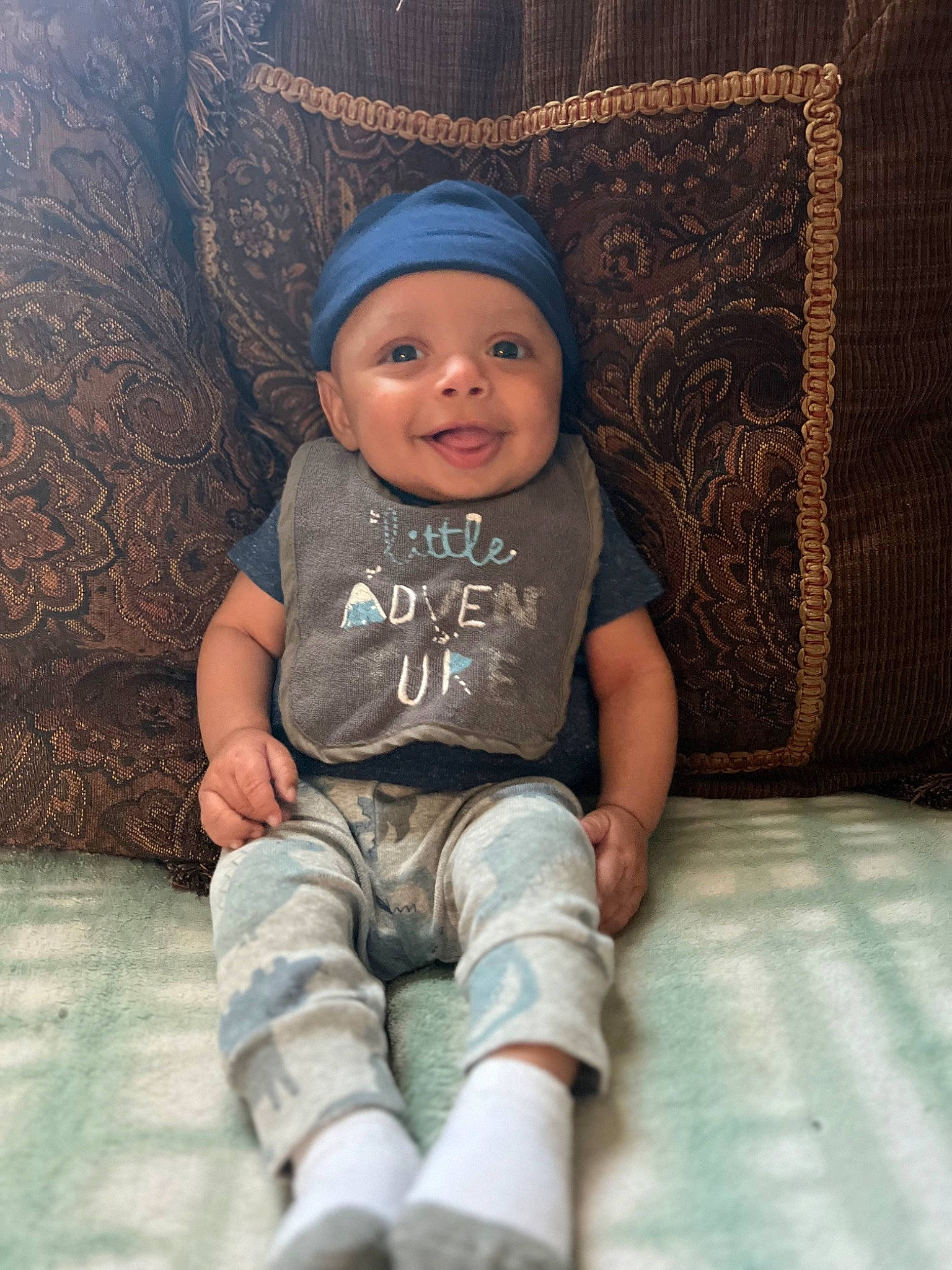 Azare is registered to the contest to win money with this photo: baby, baby_toddler_clothing, cap, cheek, electric_blue, eye, flash_photography, fun, happy, head, headgear, headwear, human_body, iris, joy, knee, person, sitting, skin, sleeve